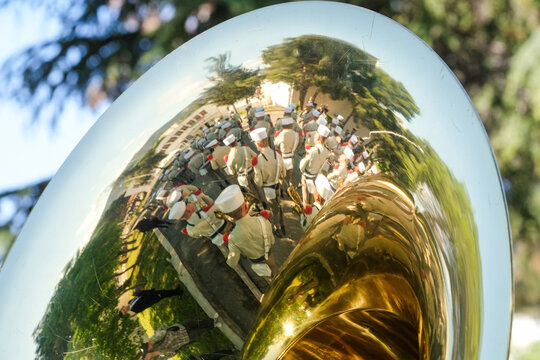 Foreign Legion ceremony reflected in a brass bell during the annual Legion commemoration in Aubagne, France