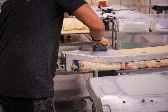Working the composite in the mould to build a drone at a military drone manufacturer in Toulouse, France