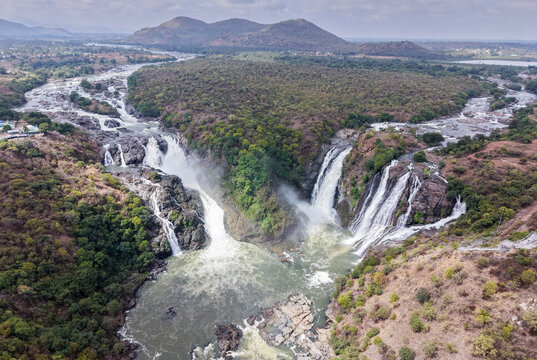 Aerial view of the twin-streamed Gaganachukki waterfall cascading, gorge, rocky terrain, picturesque landscape, drone shot in Karnataka, India.