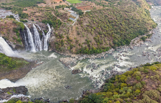 An Aerial drone shot of Gaganachukki waterfalls cascading into the Kaveri river, rocky terrain, nature, landscape, water, western ghats in Karnataka, India.