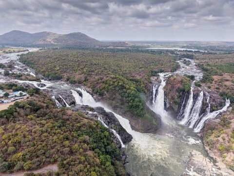 Aerial view of the twin-streamed Gaganachukki waterfall cascading, gorge, rocky terrain, picturesque landscape, drone shot in Karnataka, India.