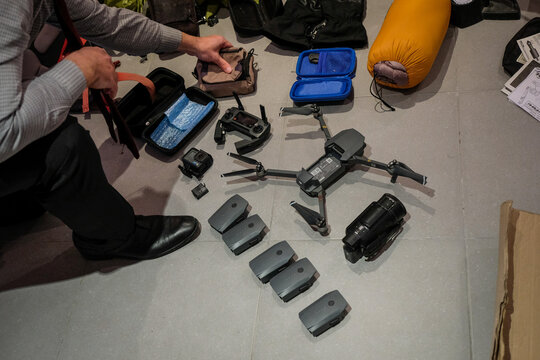 Drone and its batteries laid out at home between weekends of mountain biking in the Pyrenees, Aragnouet, France