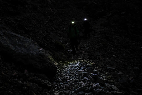 Descent of the scree by head torch below the Aiguilles d'Ansabere near Lescun, Aspe valley, France