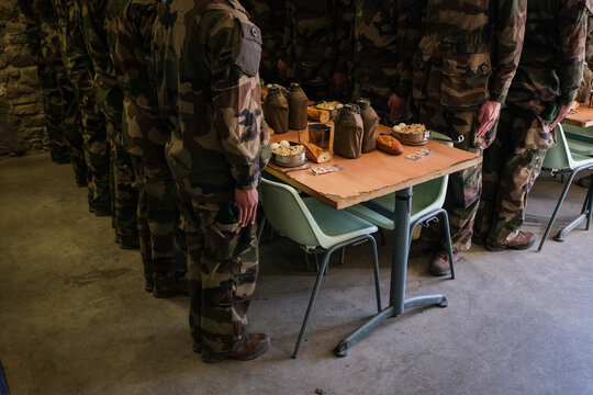 Foreign Legion recruits standing at the table before the order to sit during basic training in Castelnaudary, France