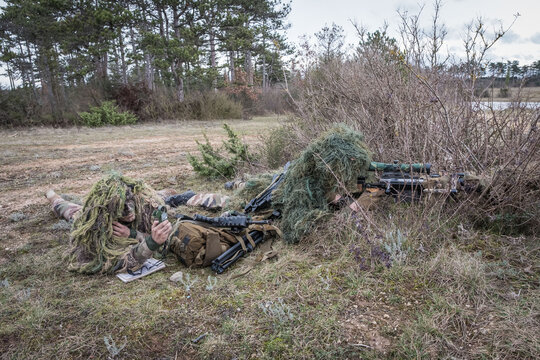 Ghillie suit of a French paratrooper sniper merging with the dry grass during training near Castres, France