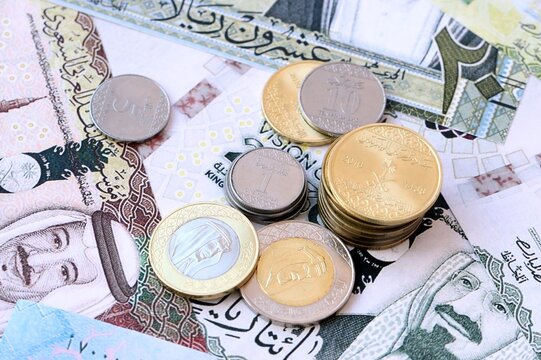 Saudi riyal money bills and coins in pile. Big amount of Saudi Arabia SAR currency cash close up