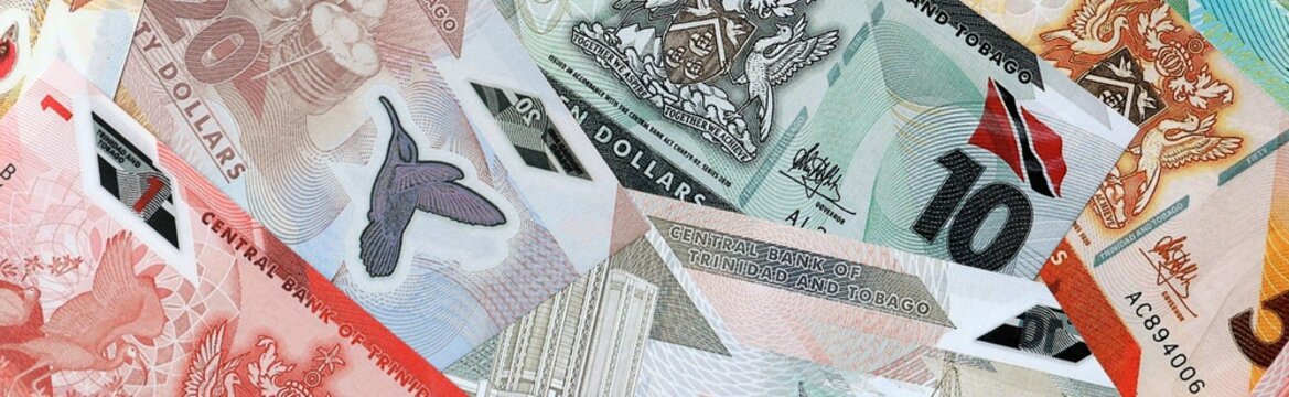 Trinidad and Tobago dollar money bills in pile on table. Trinidad and Tobago TTD currency cash