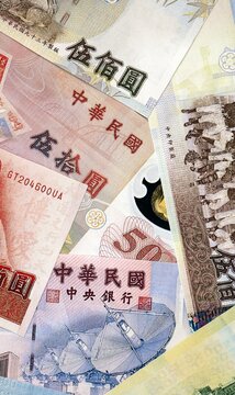 New Taiwan dollar money bills in pile on table. Taiwan TWD currency cash close up