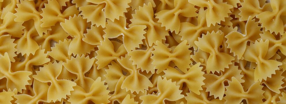 Uncooked Farfalle Pasta, Bow-Tie Macaroni Creating a Lively and Textured Background