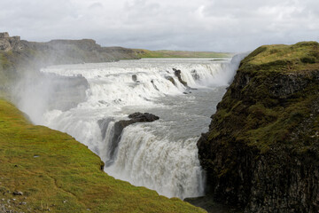 Gullfoss waterfall tumbling into a canyon with mist © Ad