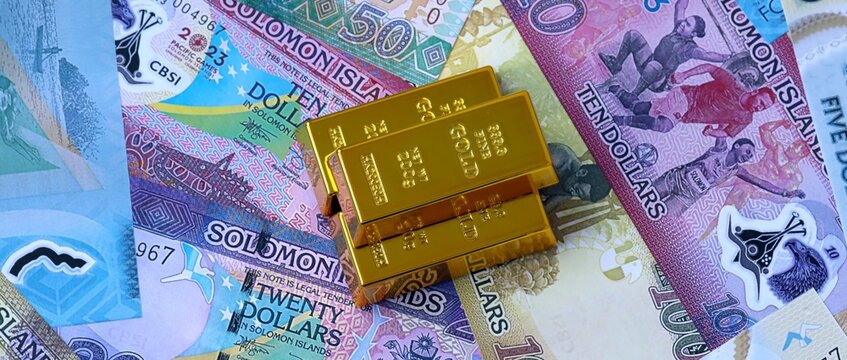 Solomon Islands dollar money bills and gold bullion bars. Solomon Islands cash of SBD currency