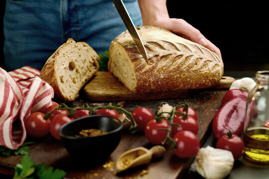 Slicing bread on table close up video