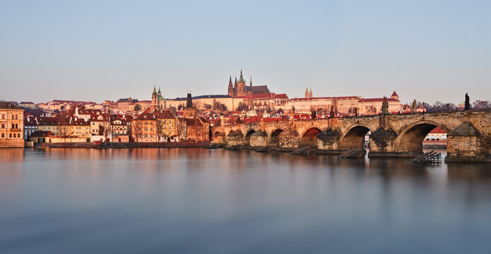 Charles Bridge stone arches and Prague Castle in morning light