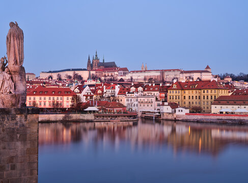 Charles Bridge statue and Prague Castle at blue hour in Prague