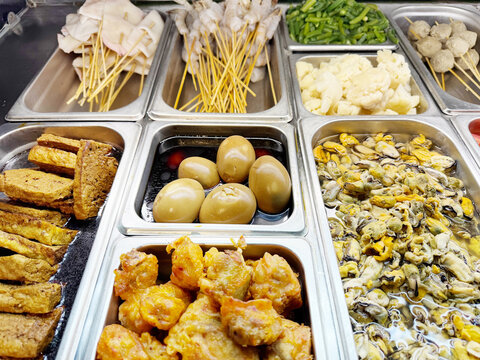 Assorted Wok Ingredients on Display in Asian Restaurant &ndash; Fresh Mushrooms, Greens, Sliced Vegetables, Various Noodles, Glass Noodles, Meatballs, Shrimp and Chicken for Custom Stir-Fry