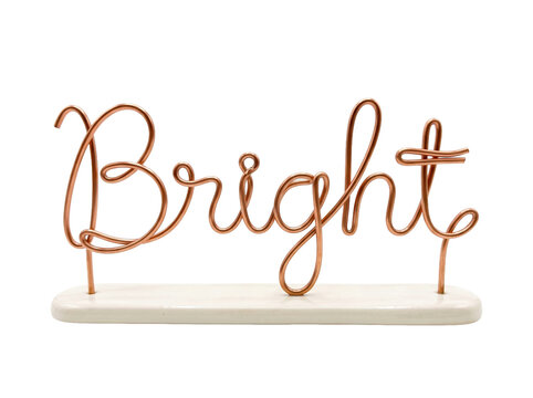 Decorative copper wire word sign spelling bright mounted on a smooth white ceramic base stand