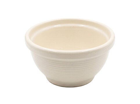 Empty cream colored ceramic mixing bowl with ribbed texture isolated on a transparent background