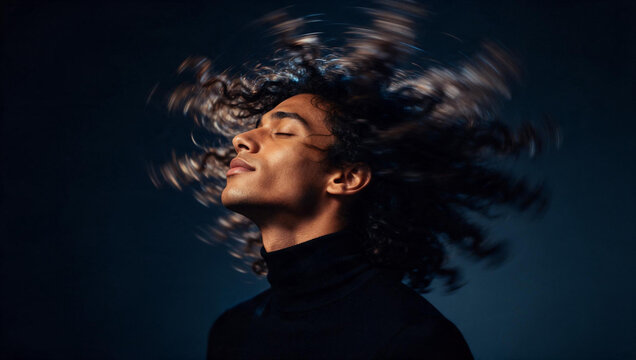 Young Man Shaking Curly Hair in Dynamic Motion
