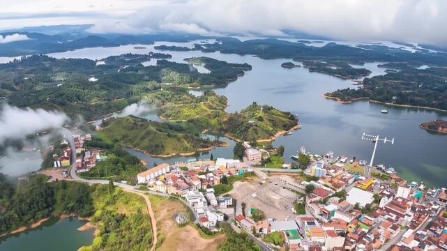 Guatap&eacute; and El Pe&ntilde;&oacute;n de Guatap&eacute; Surrounded by Reservoir Islands in Antioquia, Colombia. Time Lapse. Establishing Shot. Aerial View.