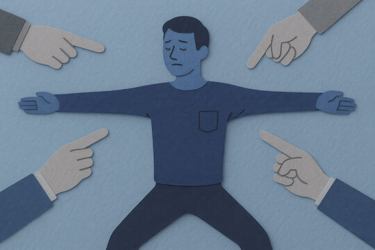 Man surrounded by pointing hands from multiple directions, arms spread wide, blue tones illustrating pressure, blame, and social stress in flat paper art style