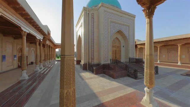 Suzuk Ota Mausoleum framed by wooden columns in Tashkent