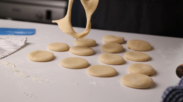 Grid pattern cookies with dough ribbons over small dough balls on white kitchen counter