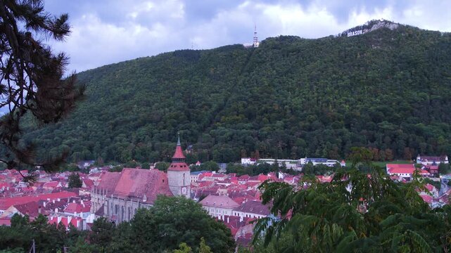 Day to night time lapse of Brasov Old Town and Mount Tampa, Romania