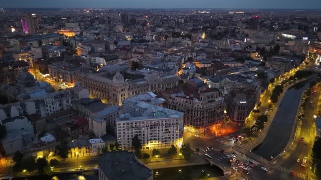 Night aerial shot of Lipscani Old Town and Dambovita River in Bucharest