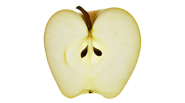 Fresh sliced yellow apple half with visible seeds and stem