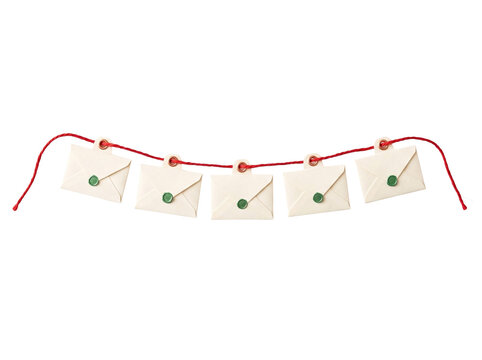 Decorative garland of small cream envelopes with green wax seals hanging on a red string line