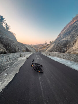 Bicycle on Asphalt Road Through Mountain Pass