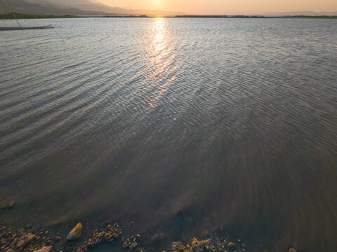 Golden Sunset Over Rippling Lake Water