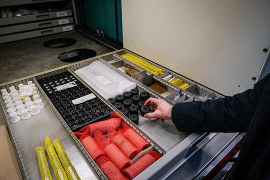 Precision rifle parts sorted in workshop drawers inside a firearms factory near Annecy, France
