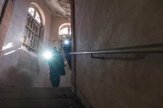 Flashlight beam and daylight crossing on a staircase during a French police tactical unit drill in Toulouse, France