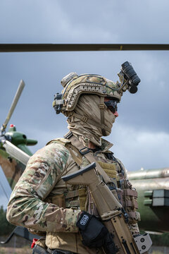 Special forces operator in full kit beside a helicopter rotor at a defence trade fair near Bordeaux, France