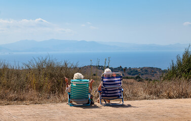 Andalusia, Spain. September 29, 2026. Two senior women looking at Strait of Gibraltar and Africa © Paolo Corazza