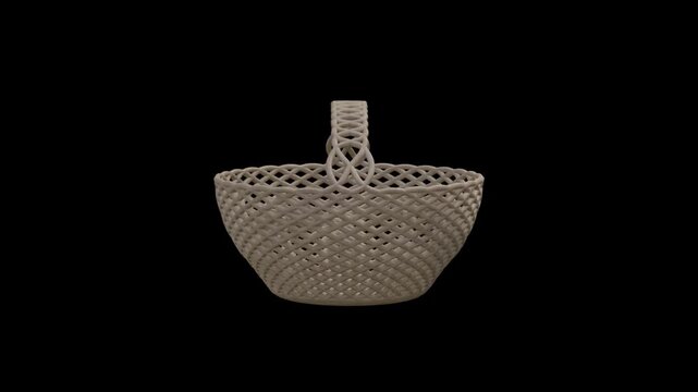 Slowly rotating woven wicker basket with handle against black background