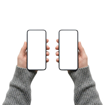 Hands in grey sweaters holding two smartphones isolated on transparent background