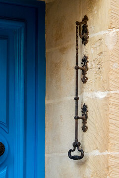 Blue Door With Antique Iron Latch And Ornate Handle On Stone Exterior Entrance