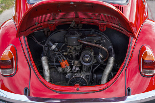 Open rear engine bay revealing the air-cooled flat-four boxer engine of a red classic 1970s Volkswagen Beetle oldtimer, highlighting timeless engineering and reliability, Subotica, Serbia, Jun 6, 2026