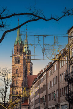 The tower of St. Lawrence's Church (St. Lorenz) in the Old Town (Altstadt) of Nuremberg, Bavaria, Germany, decorated with festive hanging lights typical of the Christmas market (Christkindlesmarkt).