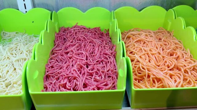 Assorted Wok Ingredients on Display in Asian Restaurant &ndash; Fresh Mushrooms, Greens, Sliced Vegetables, Various Noodles, Glass Noodles, Meatballs, Shrimp and Chicken for Custom Stir-Fry