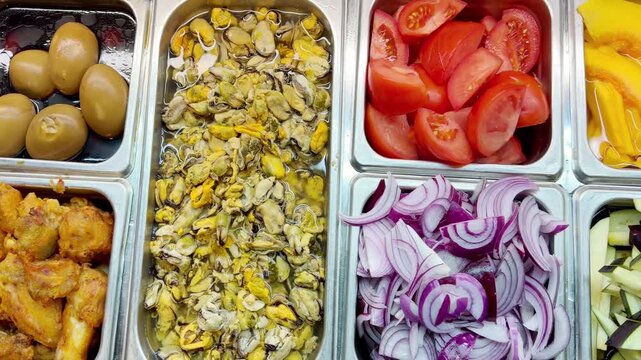 Assorted Wok Ingredients on Display in Asian Restaurant &ndash; Fresh Mushrooms, Greens, Sliced Vegetables, Various Noodles, Glass Noodles, Meatballs, Shrimp and Chicken for Custom Stir-Fry