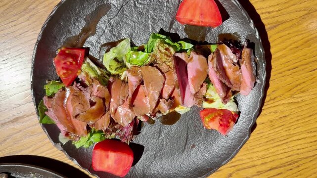 Beef Salad on Plate on Restaurant Table &ndash; Fresh Vegetable and Meat Salad Served for Lunch or Dinner