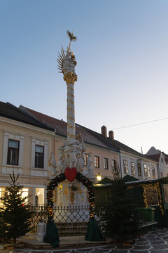 Ornate Column Monument with Garland and Lights