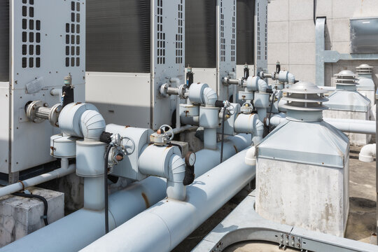 Curved Water Pipes and Ventilators on Industrial Rooftop