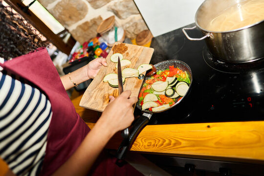 Woman cooking fresh vegetables for healthy meal