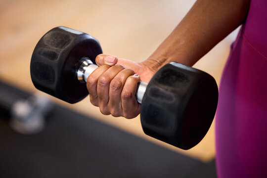 Hands gripping dumbbell