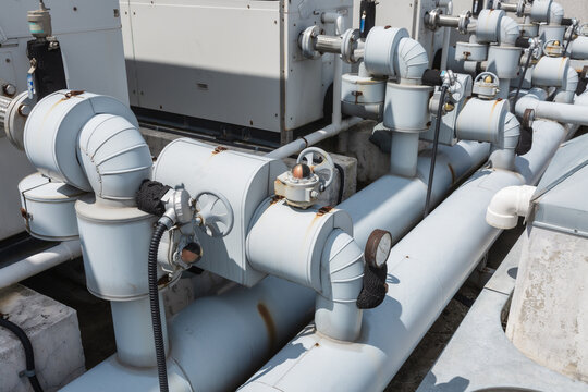 Close-up of Industrial Air Ducts and Water Pipes on Rooftop