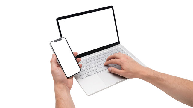 Man using a laptop and holding a smartphone with empty screens isolated on a white background